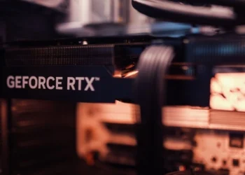 A GeForce RTX graphics card installed in a PC with its power cable connected