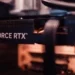 A GeForce RTX graphics card installed in a PC with its power cable connected