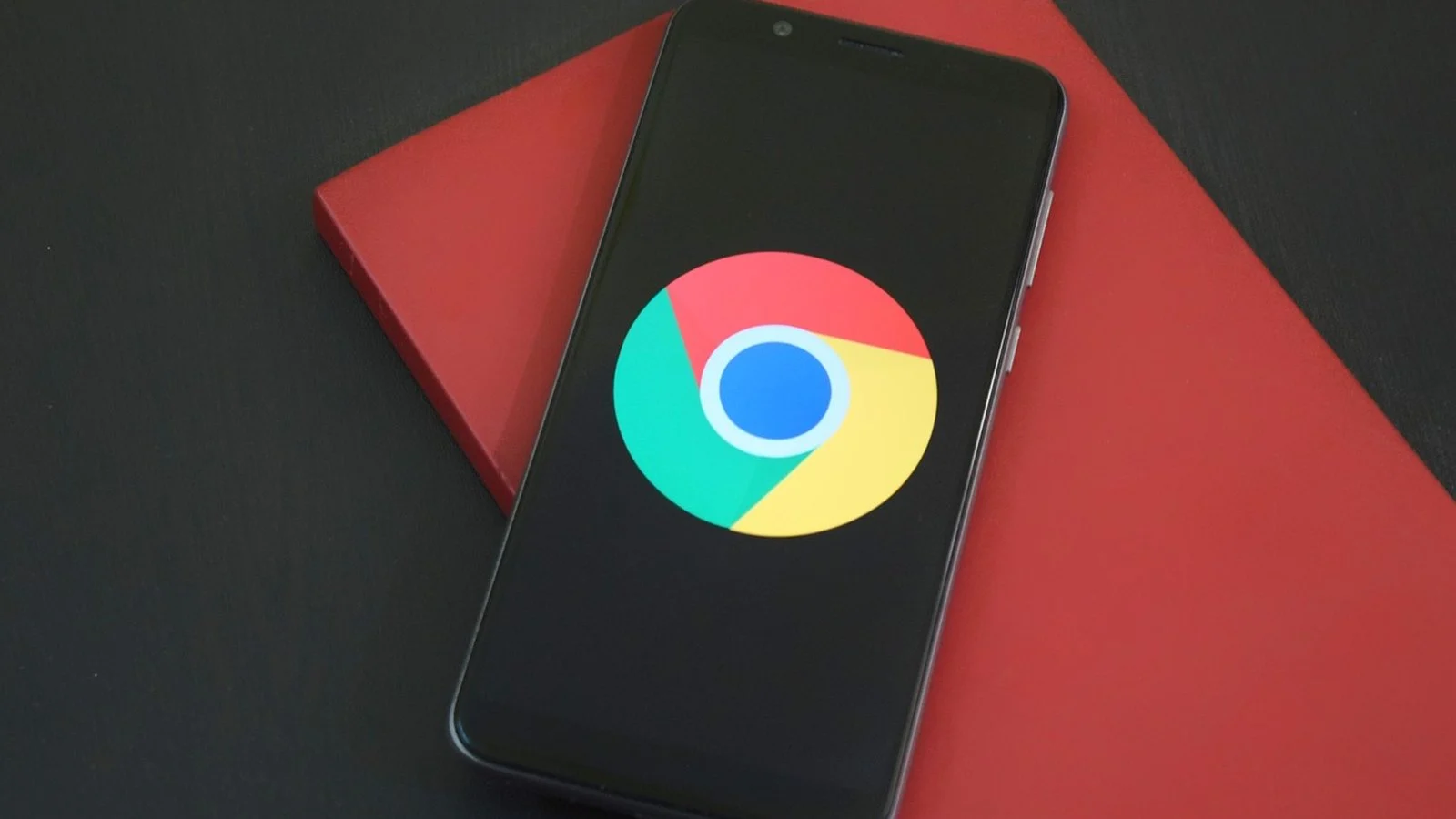 Smartphone displaying the Google Chrome logo, resting on a red box