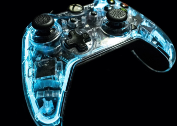 Translucent blue-lit Xbox controller glowing against a black background