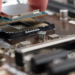 Hand placing a computer processor into a motherboard CPU socket