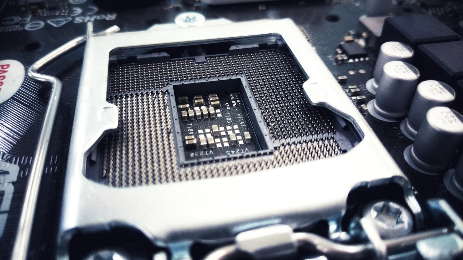 Empty CPU socket with pin array and metal retention bracket on a motherboard