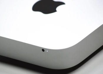 Close-up of a silver aluminum device corner with the Apple logo on top