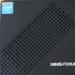 Black Minisforum mini PC with mesh vent pattern and Intel Inside sticker, viewed from above