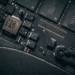 Close-up of a dusty laptop circuit board with black memory chips and screws