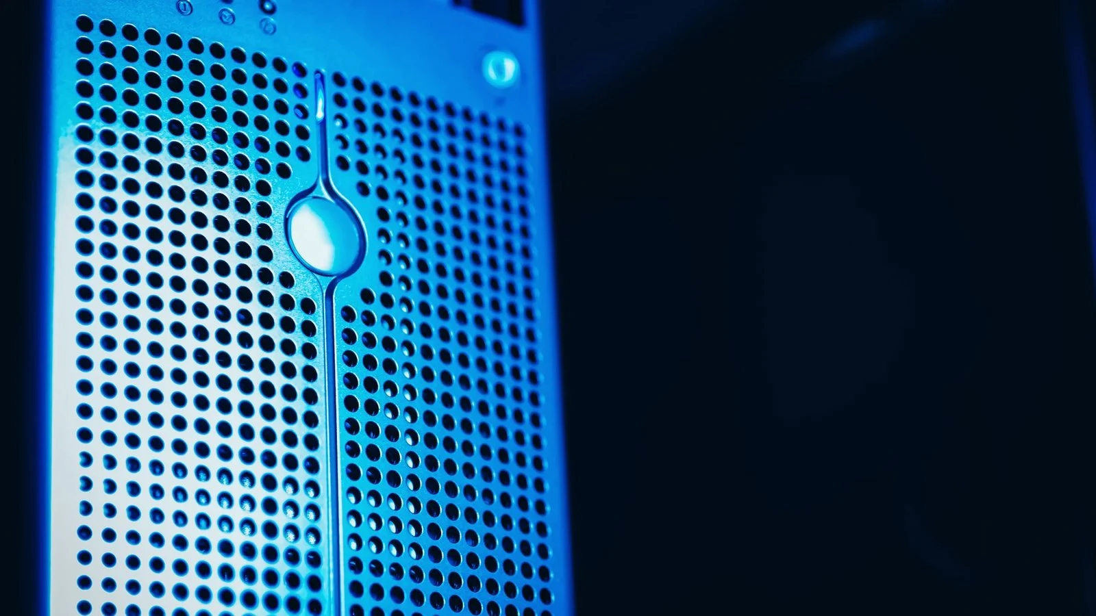 Close-up of a blue-lit perforated server panel with a teardrop-shaped LED indicator