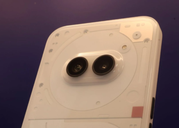 Close-up of a white smartphone's transparent back panel with visible screws and a pill-shaped dual-camera module
