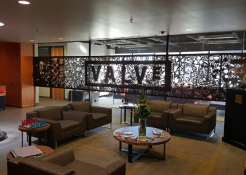 Valve office lobby with a laser-cut metal Valve logo wall and lounge seating