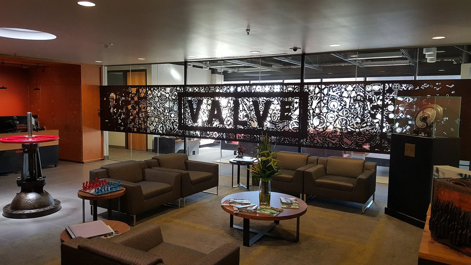 Valve office lobby with a laser-cut metal Valve logo wall and lounge seating