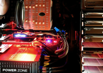 Interior of a red-lit PC case showing a PSU labeled Power Zone and drive bays