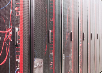 Row of server racks with mesh doors and red and blue cables visible inside