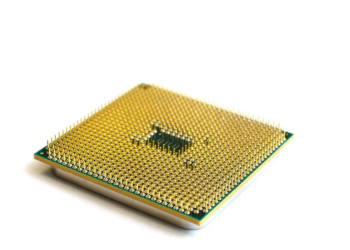 Close-up of a computer processor's gold pin grid array on white background