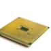 Close-up of a computer processor's gold pin grid array on white background