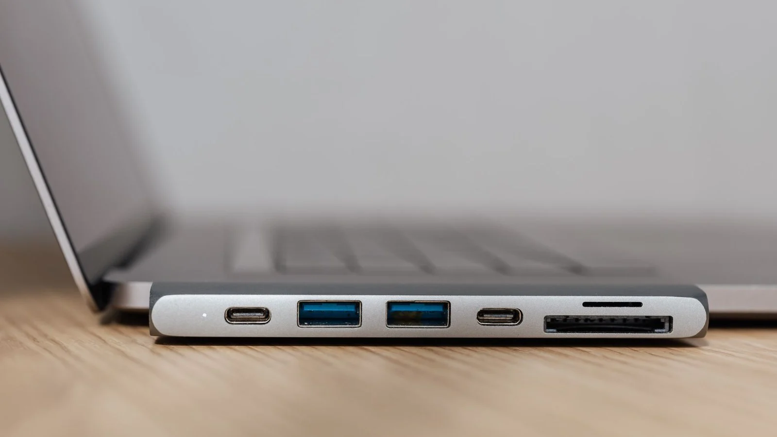 Close-up of a laptop's side ports: two USB-C, two USB-A, and an SD card slot