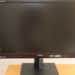 ASUS ProArt monitor with black screen off, on a stand, against a white wall