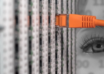 Orange network cable plugged into a server patch panel, with a ghostly eye superimposed over binary code