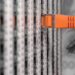 Orange network cable plugged into a server patch panel, with a ghostly eye superimposed over binary code