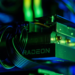 A Radeon graphics card installed in a PC case, lit by green and blue ambient light