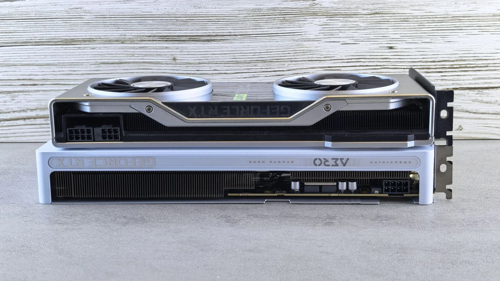 Two GeForce RTX graphics cards stacked on top of each other, seen from the side