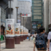 Street-side cylindrical pillars advertising Final Fantasy Digital Card Game in a Japanese shopping district