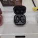 Three Samsung earbud cases with bean-shaped in-ear buds on a display table