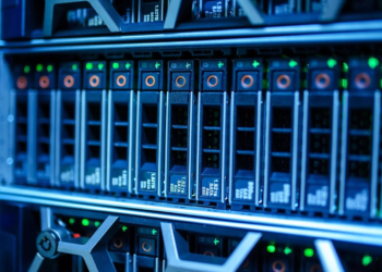 Close-up of blue-lit server rack with rows of hot-swappable SSD drive trays