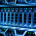 Close-up of blue-lit server rack with rows of hot-swappable SSD drive trays