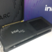 Intel Arc B580 graphics card resting against its retail packaging boxes