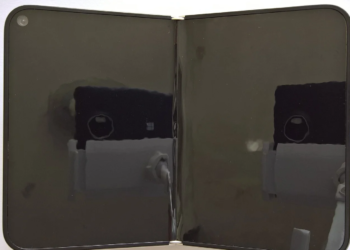White folding smartphone open flat with two dark reflective screens joined by a hinge