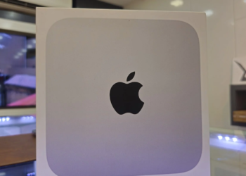 Sealed white Apple product box with black Apple logo on a store shelf