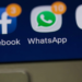 Close-up of a phone screen showing Facebook and WhatsApp app icons with notification badges