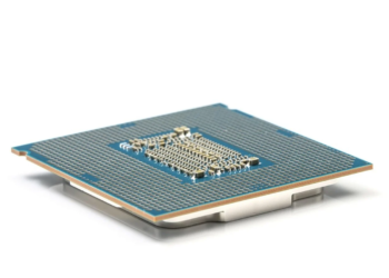Underside of a CPU package showing the pin substrate and gold contact pads on a white background