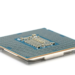 Underside of a CPU package showing the pin substrate and gold contact pads on a white background
