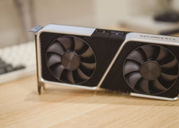 Silver and black GeForce RTX graphics card with two fans on a wooden desk