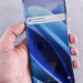 Hand holding a smartphone showing a lock screen update download progress bar
