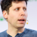 Man speaking into a headset microphone at a conference panel