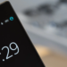 Close-up of a smartphone corner showing a clock lock screen reading 10:29 with battery at 83%