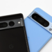 Two Pixel smartphones, black and light blue, lying face-up showing camera bars, no charging accessory visible