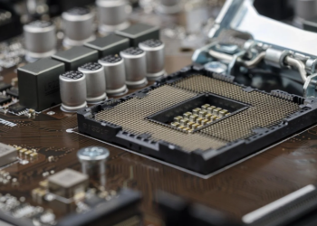 Empty CPU socket with open retention bracket on a motherboard, no processor installed