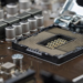 Empty CPU socket with open retention bracket on a motherboard, no processor installed