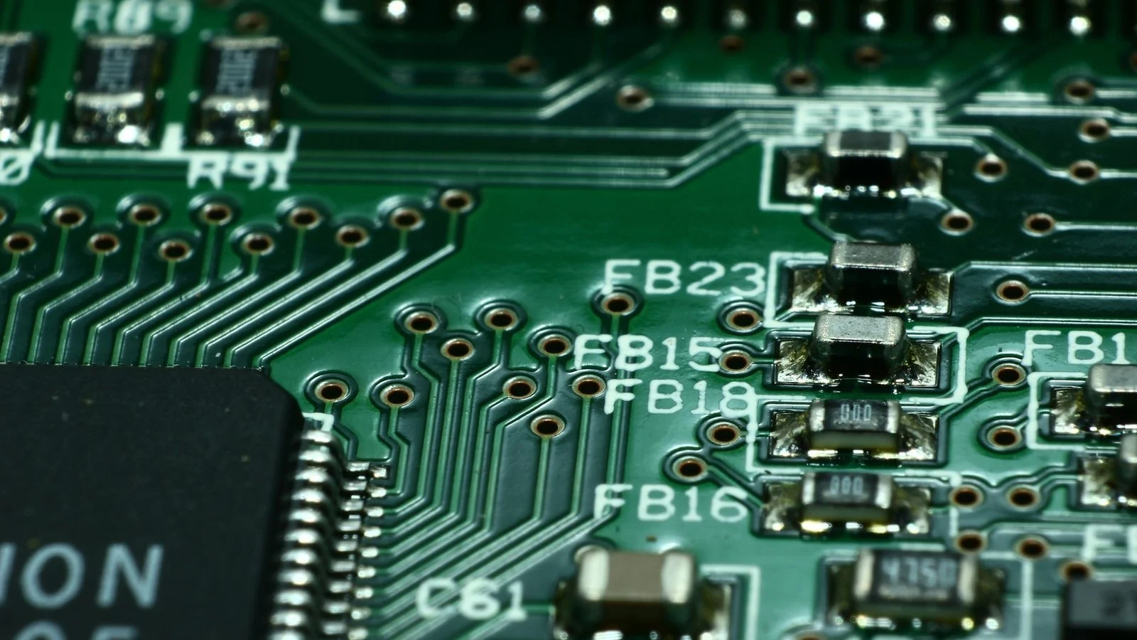Close-up of a green circuit board showing ferrite bead labels FB15, FB16, FB18, FB23 and surface-mount components