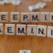 Wooden Scrabble tiles spelling DEEPMIND and GEMINI on a wood table