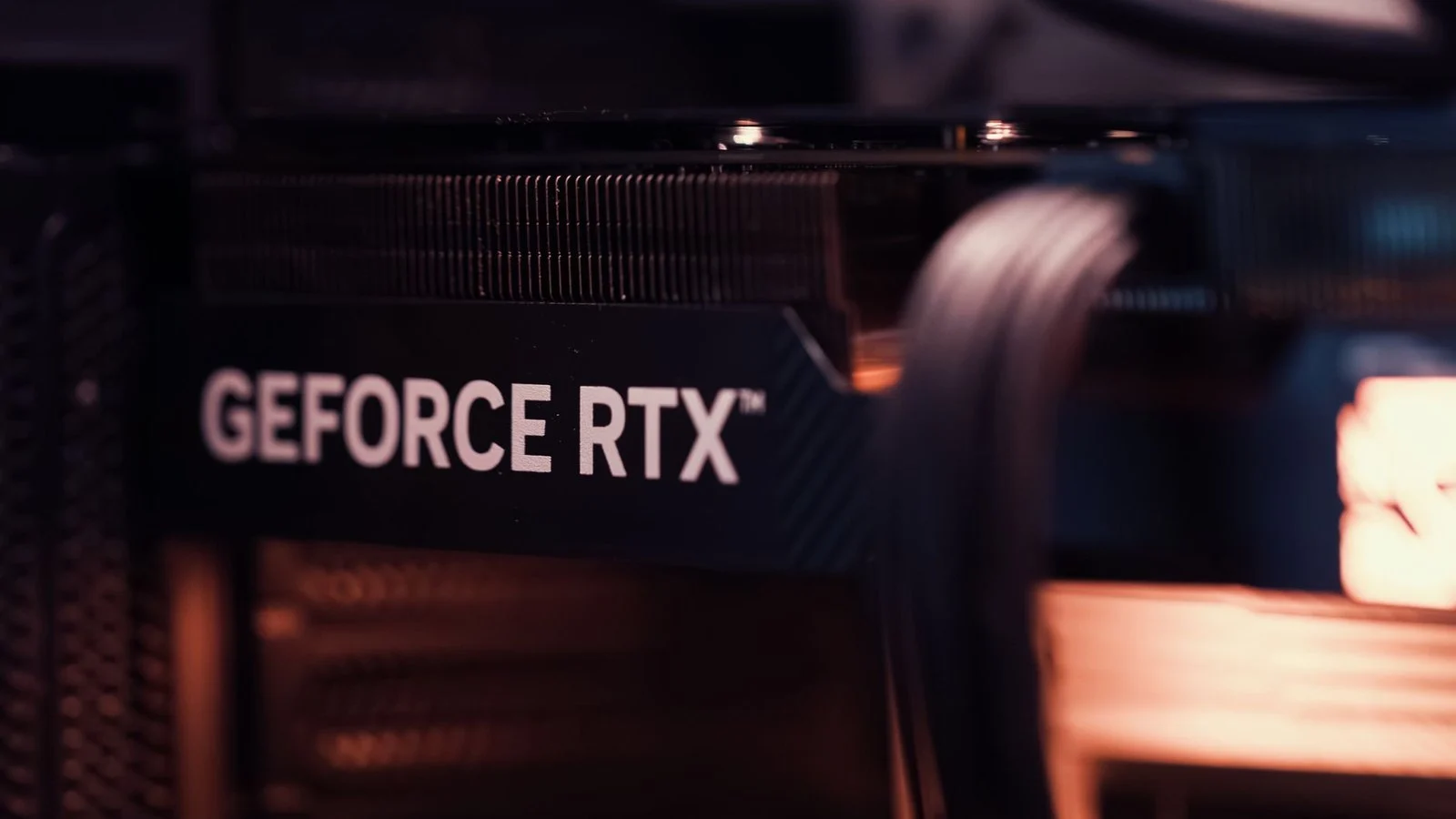 Close-up of a GeForce RTX graphics card heatsink fins inside a PC case