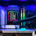 Close-up inside a PC case showing a GeForce RTX card, AIO cooler, RGB fans and RAM under blue lighting
