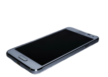 Silver Android smartphone with screen off, physical home button, lying face-up at an angle