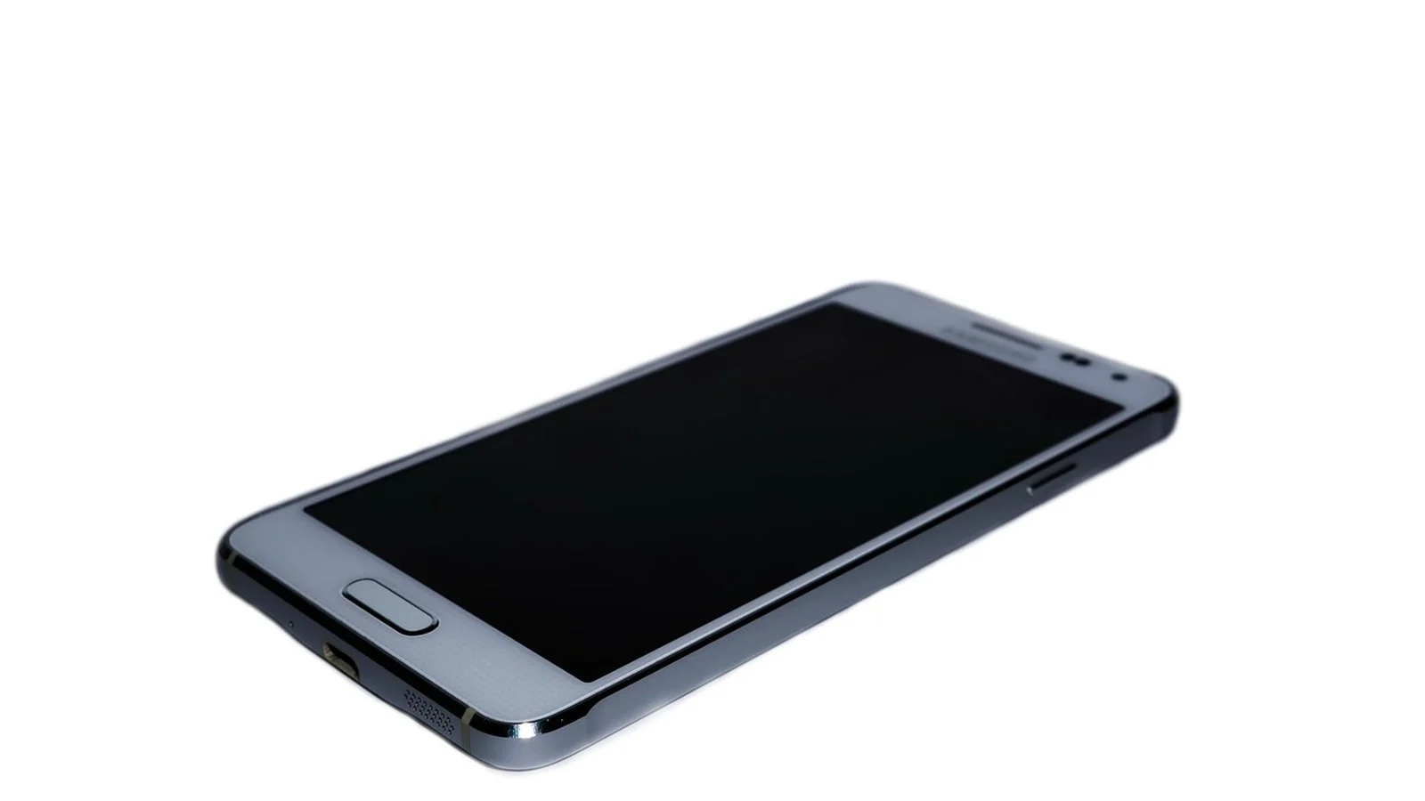 Silver Android smartphone with screen off, physical home button, lying face-up at an angle