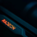 Close-up of a dark graphics card edge with an illuminated red-orange Radeon logo