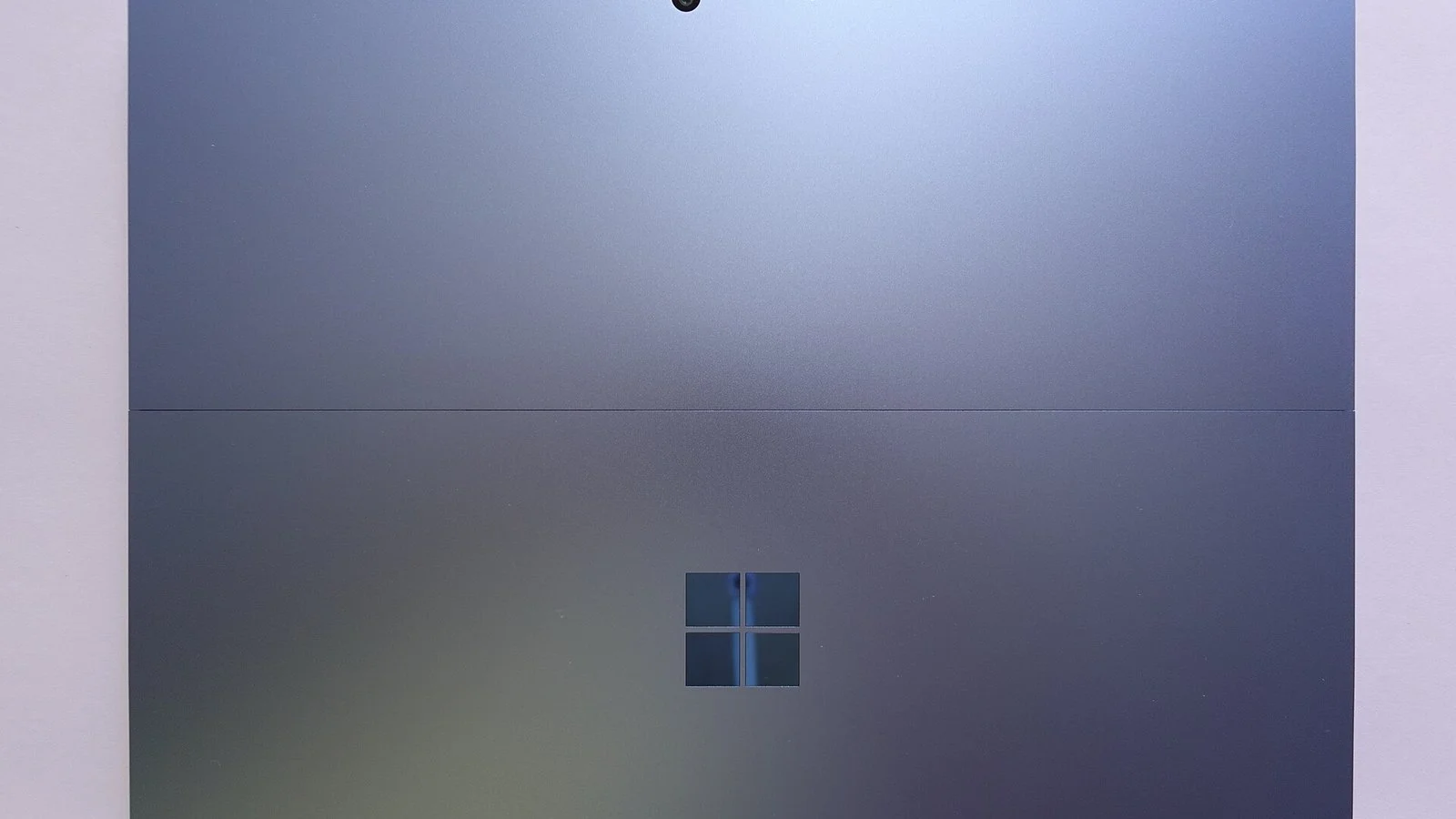 Extreme close-up of a Windows device's grey metal back panel with the Windows logo