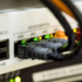 Rear panel of a networking device with USB, COM and ethernet ports connected to patch cables
