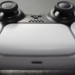 Close-up of a white and black PlayStation DualSense controller's touchpad and joysticks